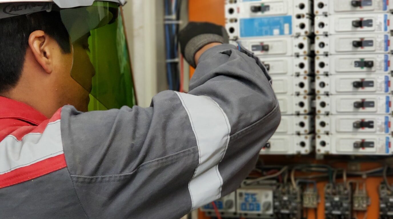 Engineer adjusting a control panel.